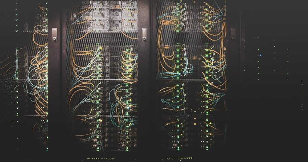 Rows of servers in a data center, representing the AI infrastructure buildout now funded by corporate bond issuance